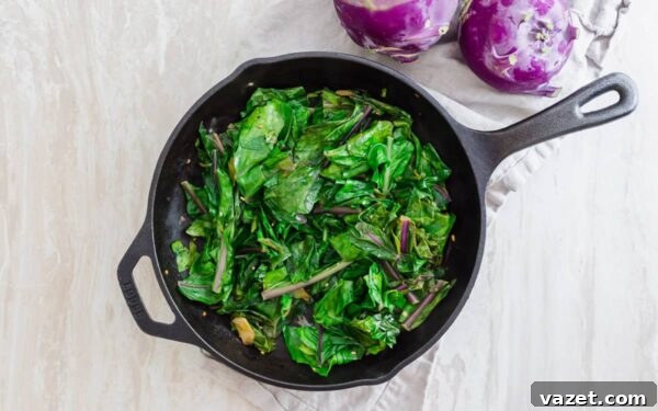 Sautéed kohlrabi greens in a skillet.