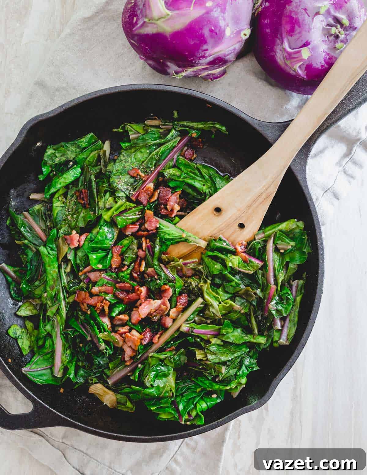 Sautéed kohlrabi greens in a skillet with crispy bacon. Close-up of vibrant kohlrabi greens sautéing in a cast iron skillet, intermingled with crispy bacon bits.