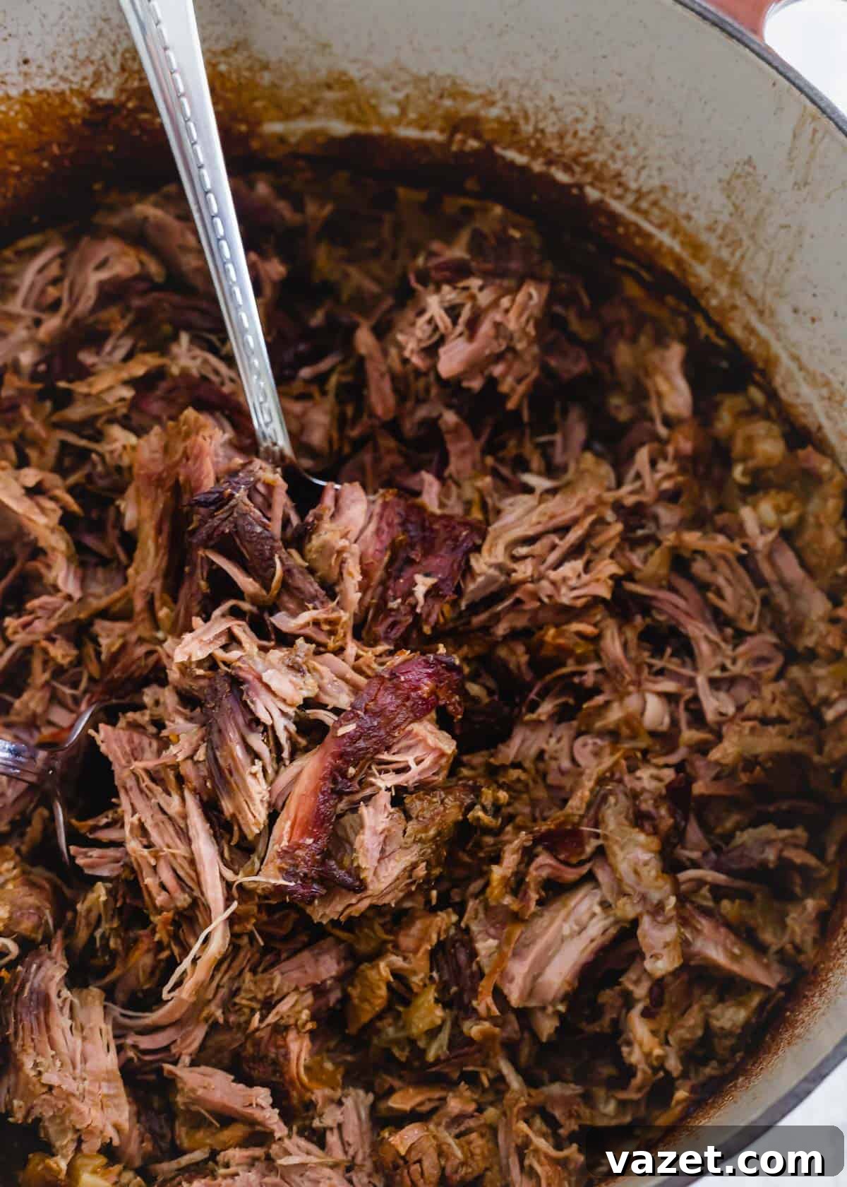 Tender, juicy and shredded braised leg of lamb in a Dutch oven. Tender, juicy and shredded braised leg of lamb in a Dutch oven.