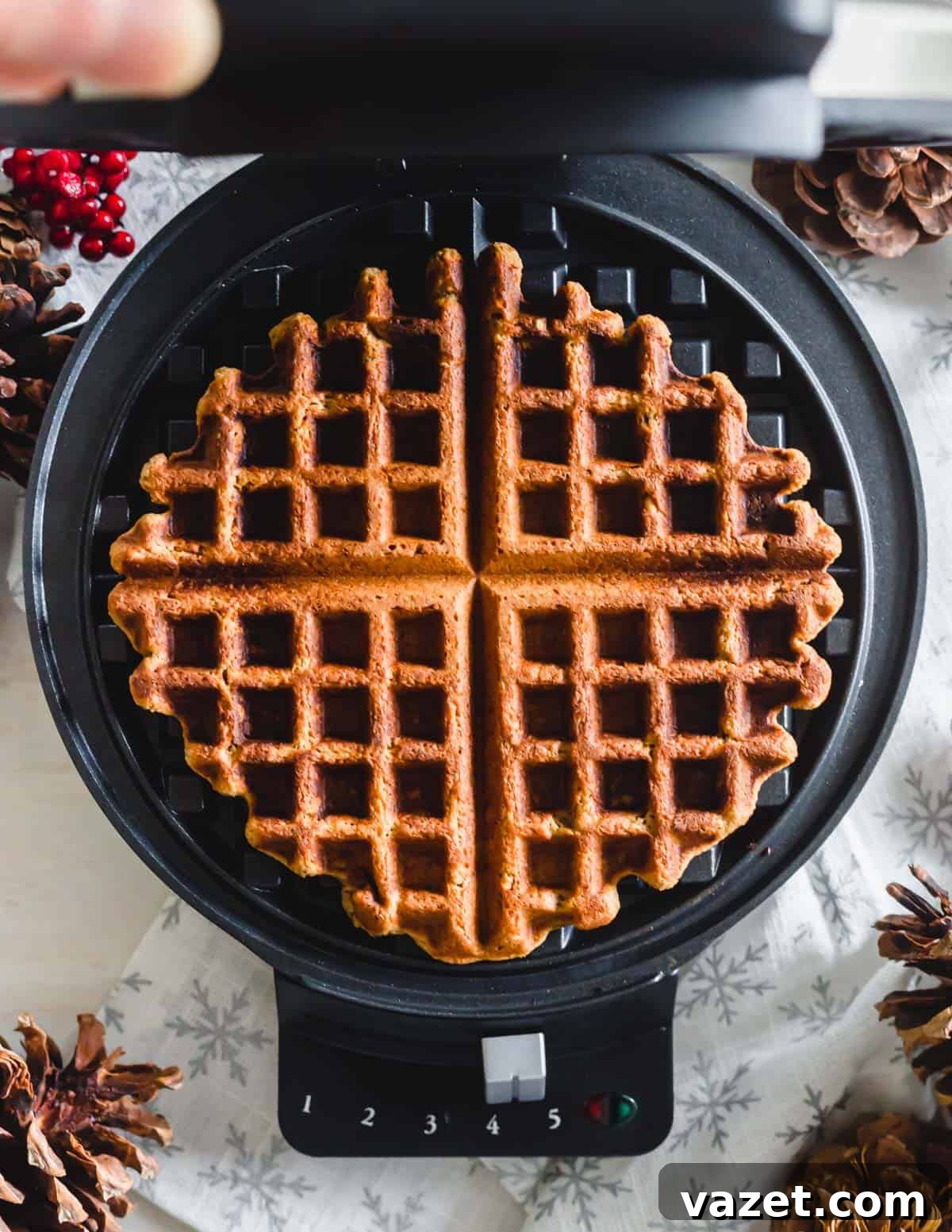 A perfectly cooked gingerbread waffle, golden brown and crispy, resting in a hot waffle iron.