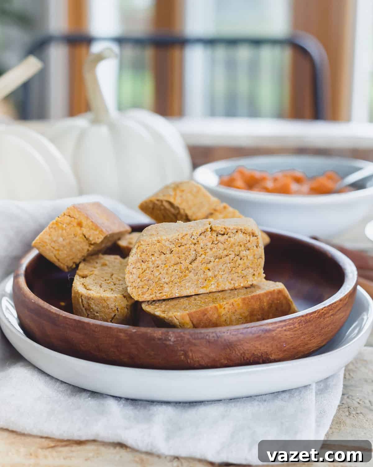Pumpkin biscotti recipe on a plate atop a wooden table setting.