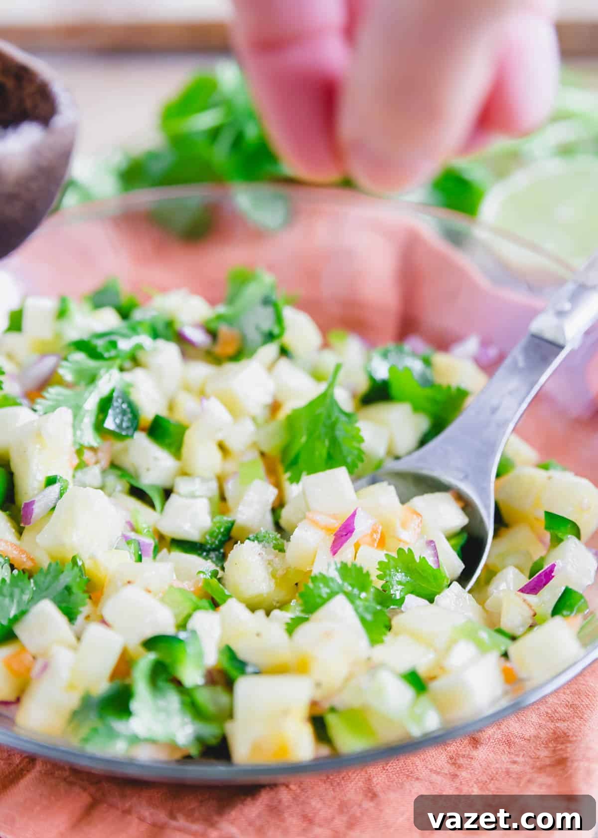Seasoning pineapple salsa with salt in a bowl. Seasoning pineapple salsa with salt in a bowl.