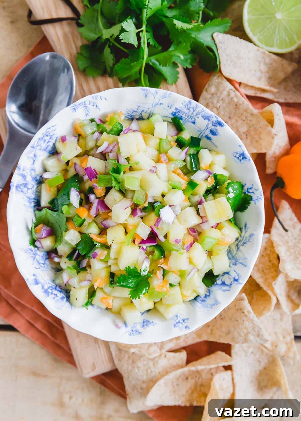 Habanero pineapple salsa in a blue and white howl with tortilla chips on the side. Habanero pineapple salsa in a blue and white howl with tortilla chips on the side.
