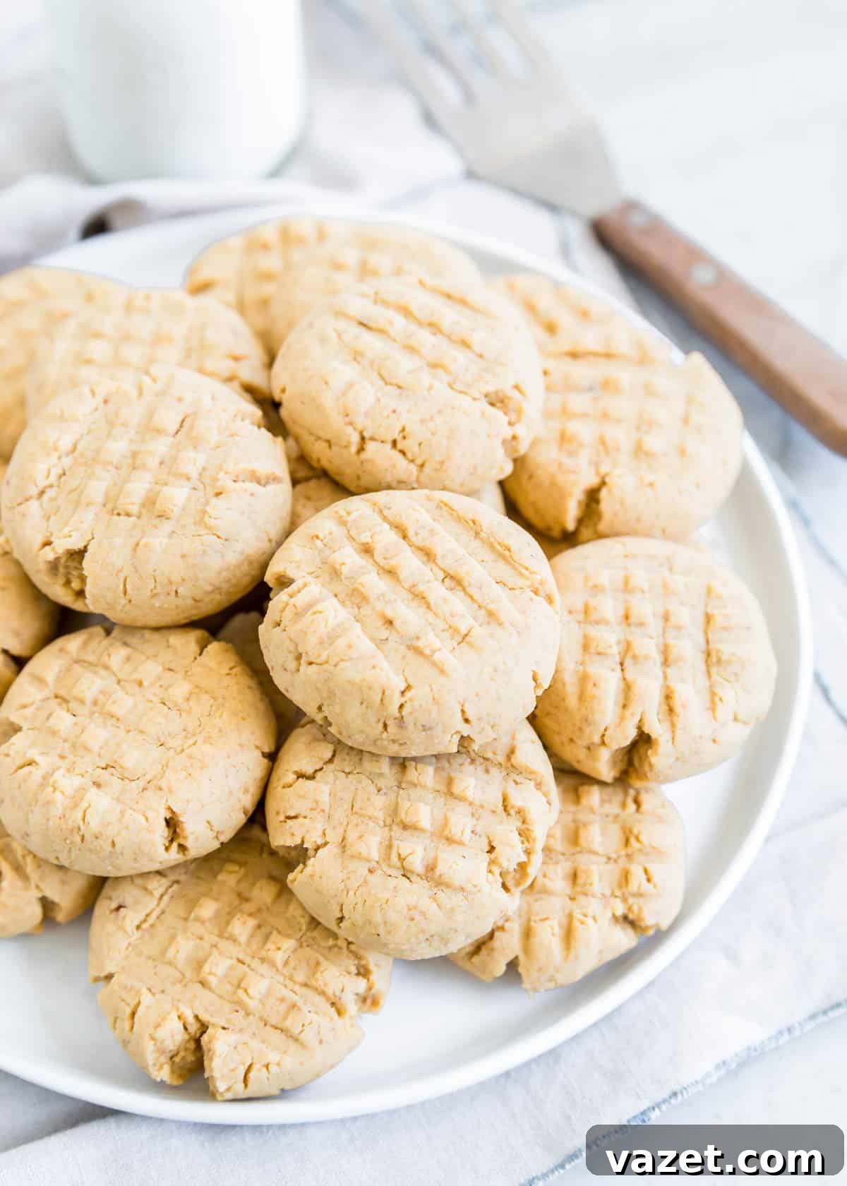 Flourless Peanut Butter Delights 5 Criss cross gluten-free peanut butter cookies piled on a plate.