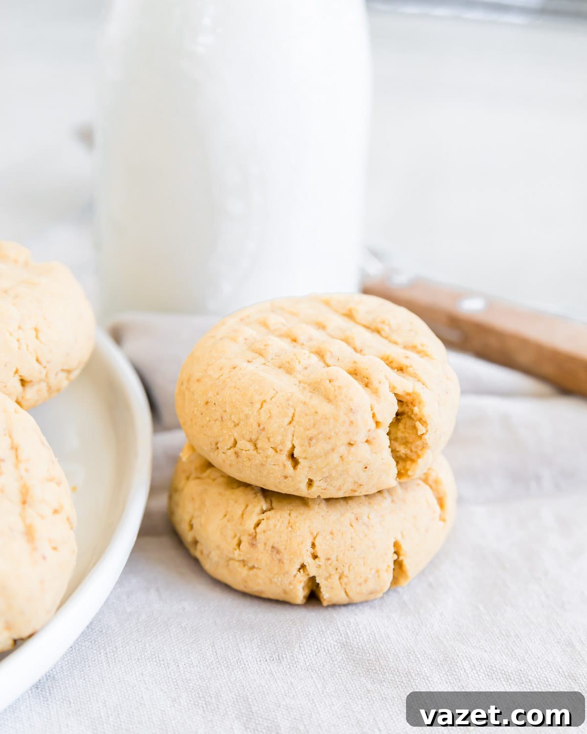 Flourless Peanut Butter Delights 6 Two gluten-free peanut butter cookies stacked next to a bottle of milk.