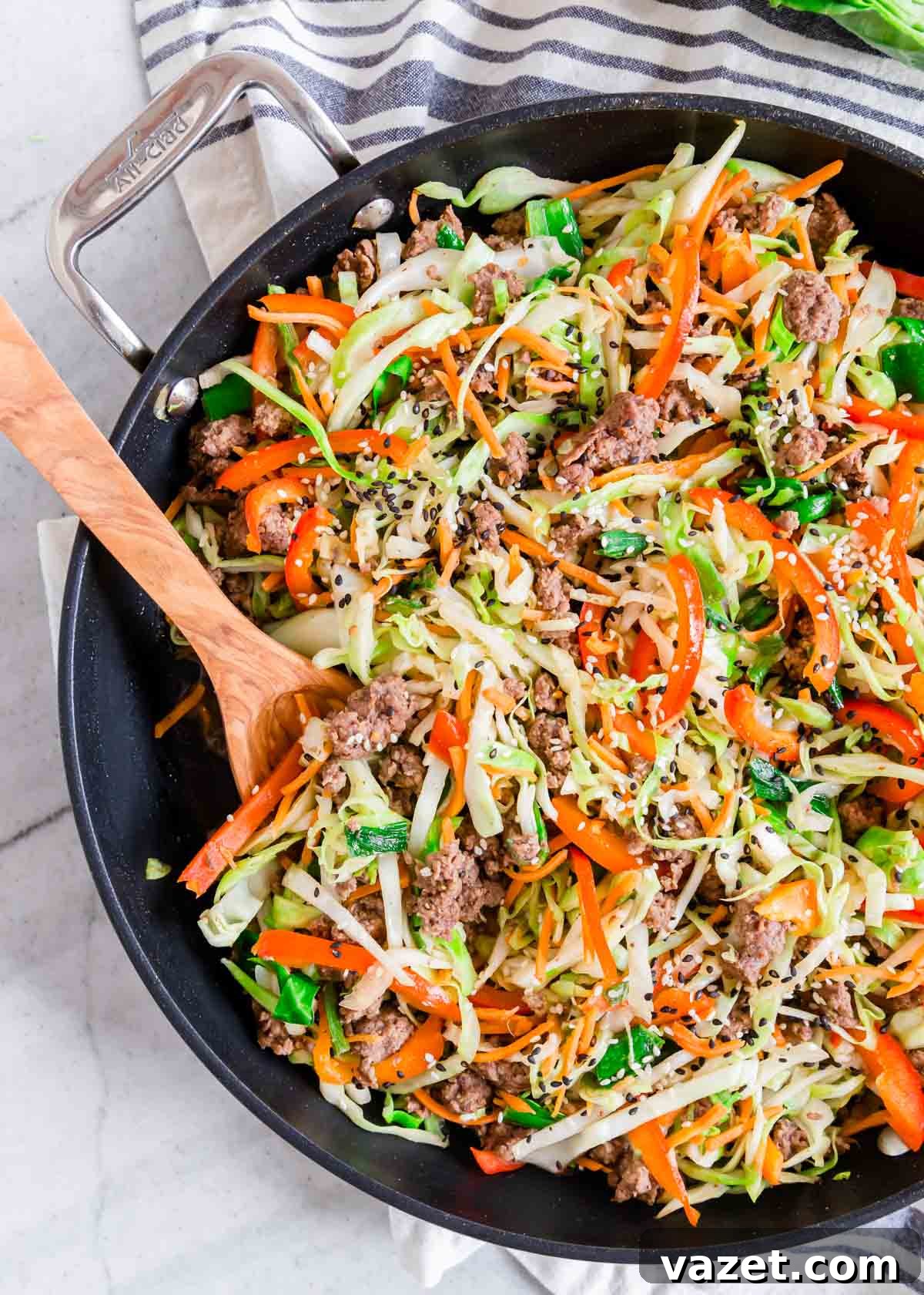 The Ultimate Guide to Freezing Cabbage 4 Ground beef cabbage skillet in a pan with a wooden serving spoon, a comforting meal.