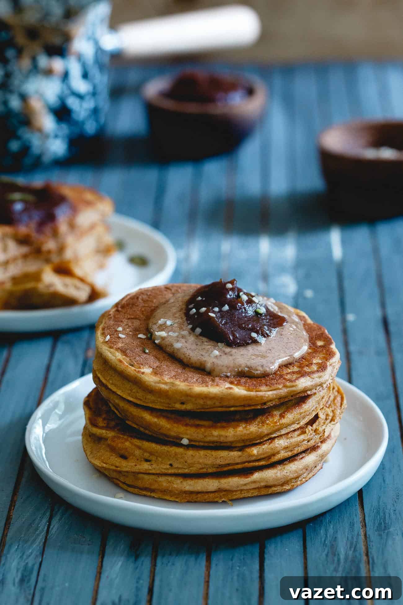 Fluffy pumpkin protein pancakes stacked high with syrup, a perfect cozy fall breakfast.