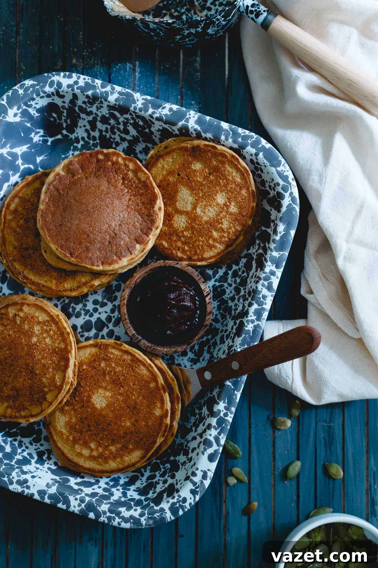 A close-up of golden pumpkin protein pancakes, ready to be drizzled with syrup and enjoyed for a healthy start to the day.