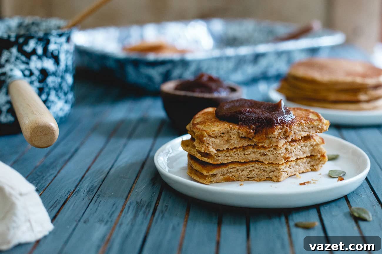 A vibrant close-up of pumpkin protein pancakes with a fork, emphasizing their delicious appeal and the desire to enjoy a hearty breakfast.