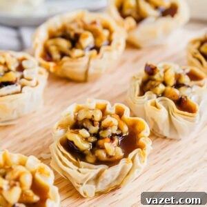Bite-Sized Pumpkin Delights 8 Pumpkin pie bites lined up on a wooden cutting board.