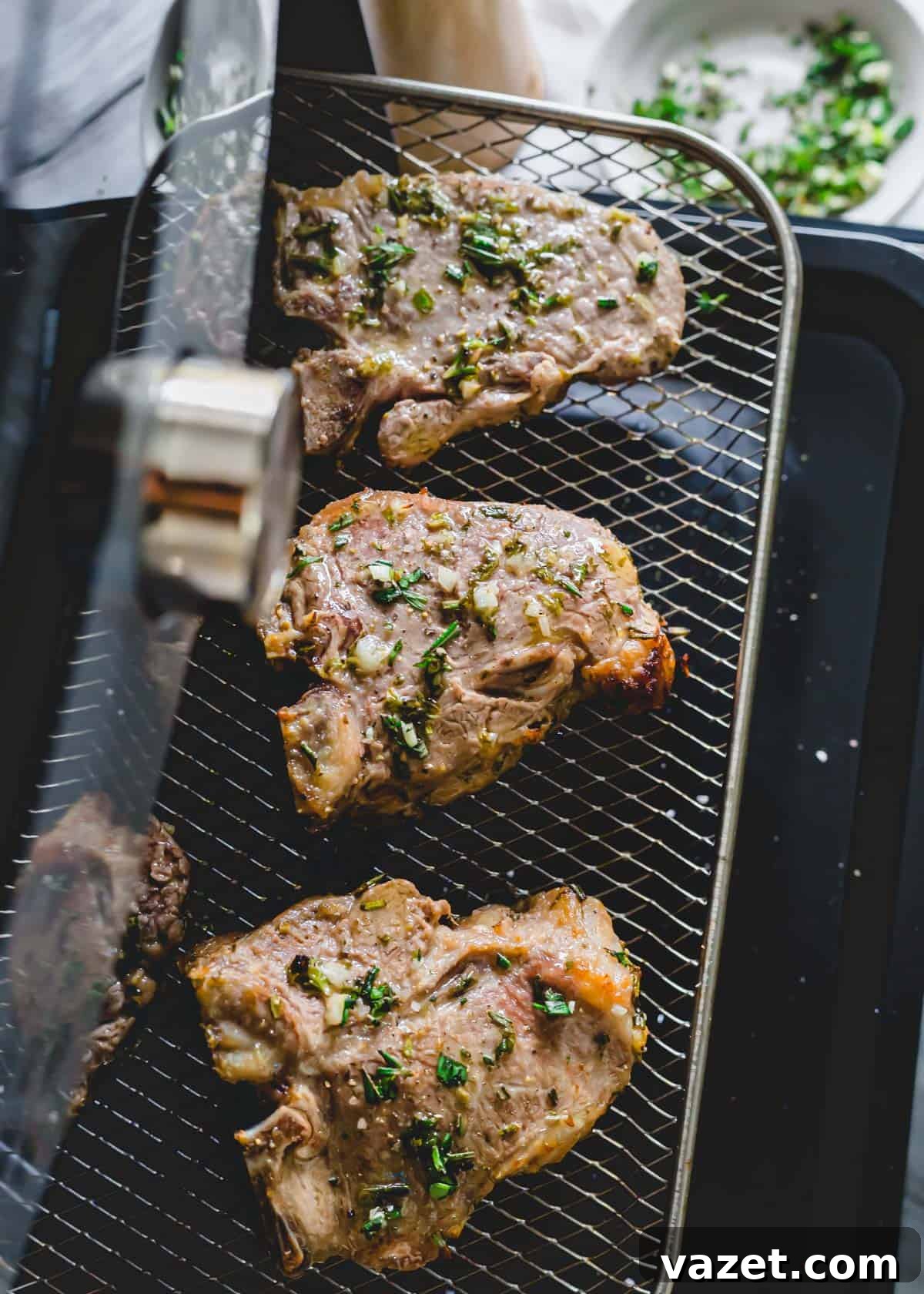 Air fryer lamb chops on rack.