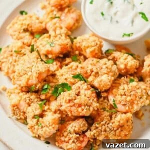 Quick Baked Shrimp Poppers 11 A plate of popcorn shrimp with a dipping sauce.