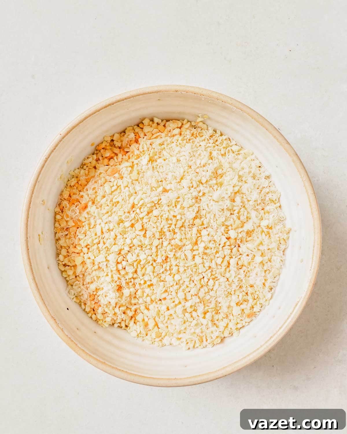 Quick Baked Shrimp Poppers 5 A bowl of plain breadcrumbs, essential for the crispy coating, sitting on a clean white surface.
