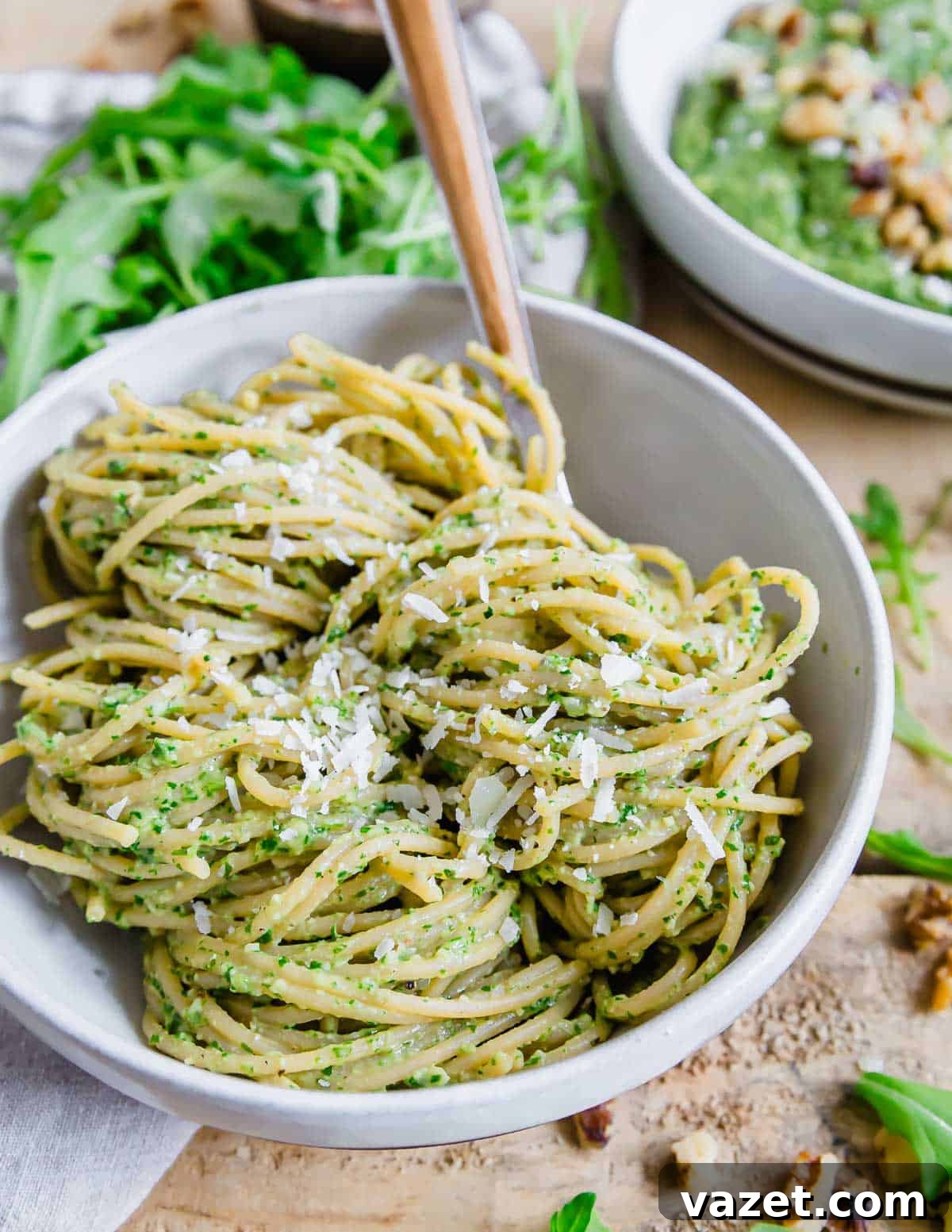 Arugula pesto pasta with walnuts and parmesan cheese.