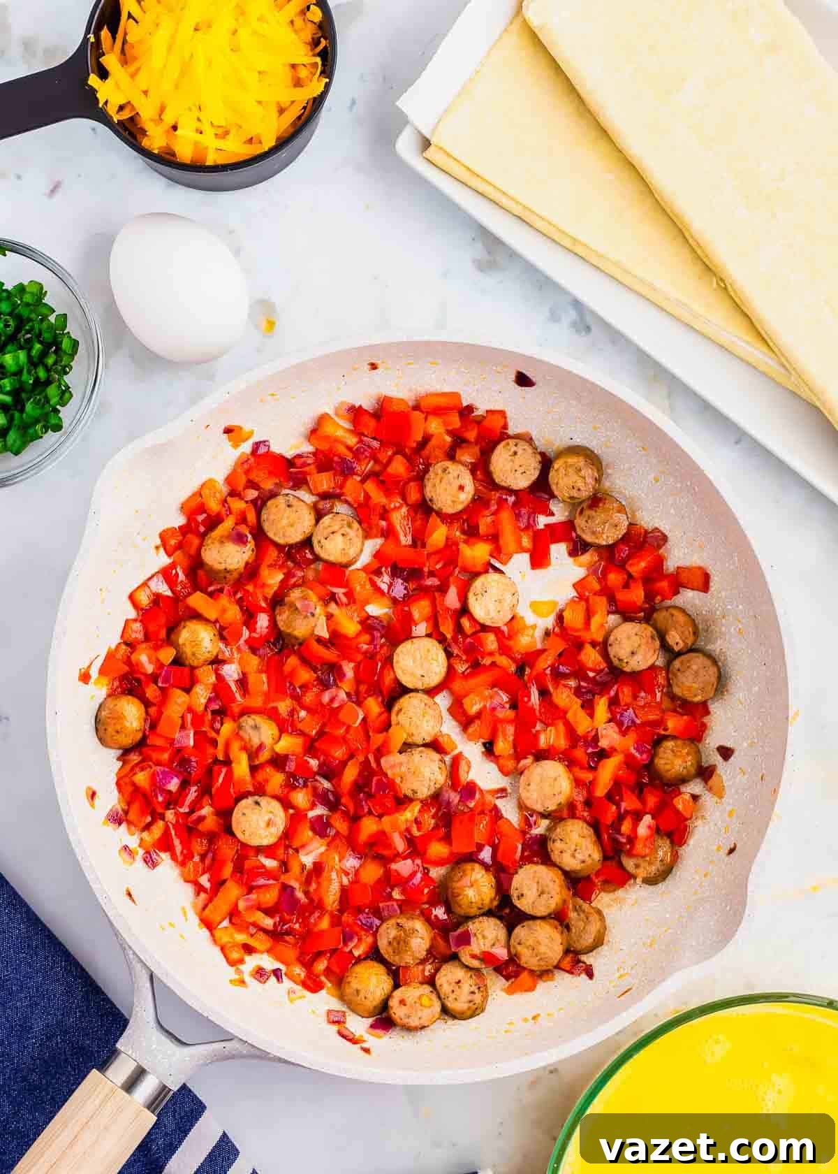 Artisan Stuffed Pockets 4 A frying pan with eggs, sausage, peppers and cheese.