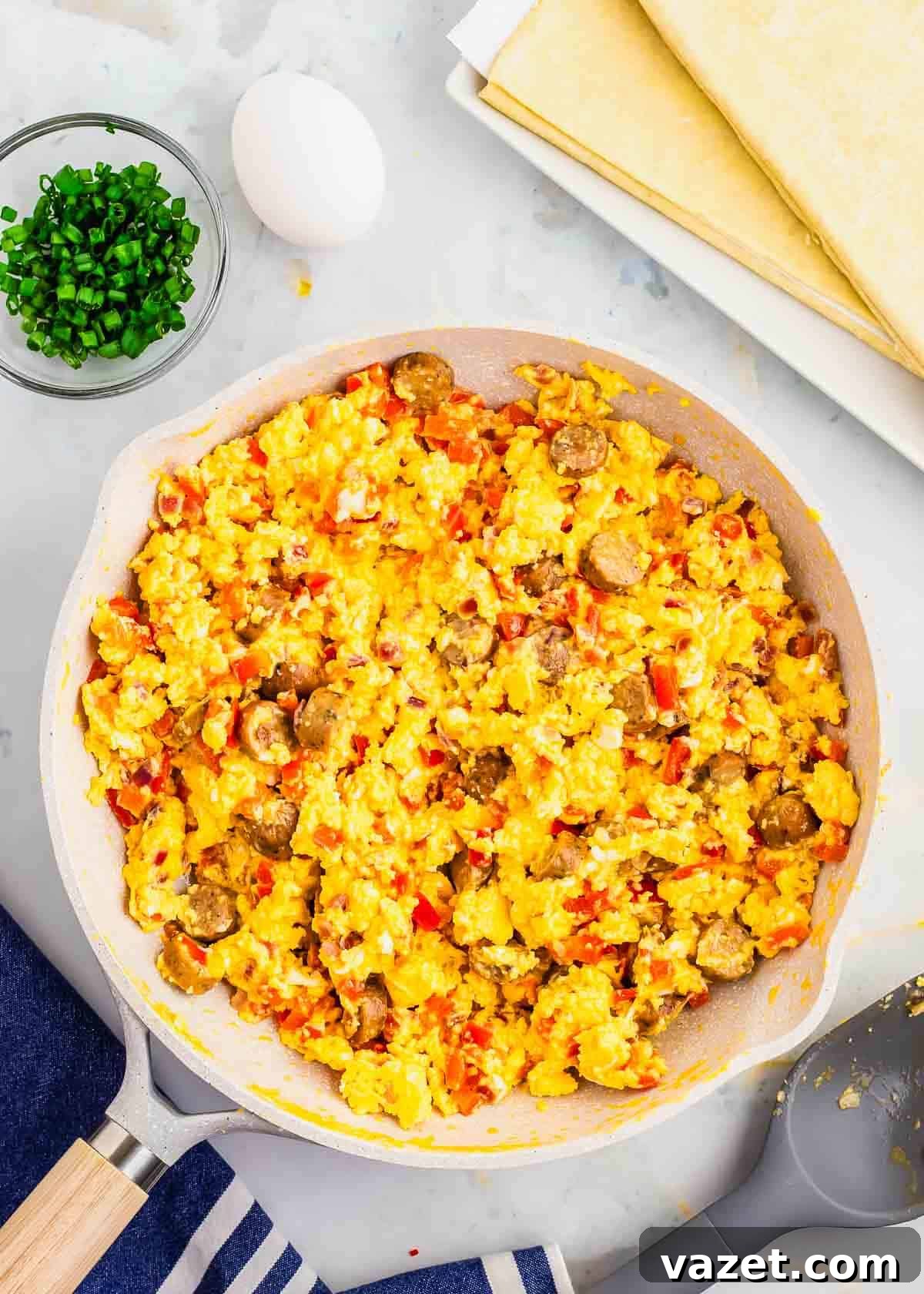 Artisan Stuffed Pockets 7 A skillet filled with scrambled eggs and vegetables.