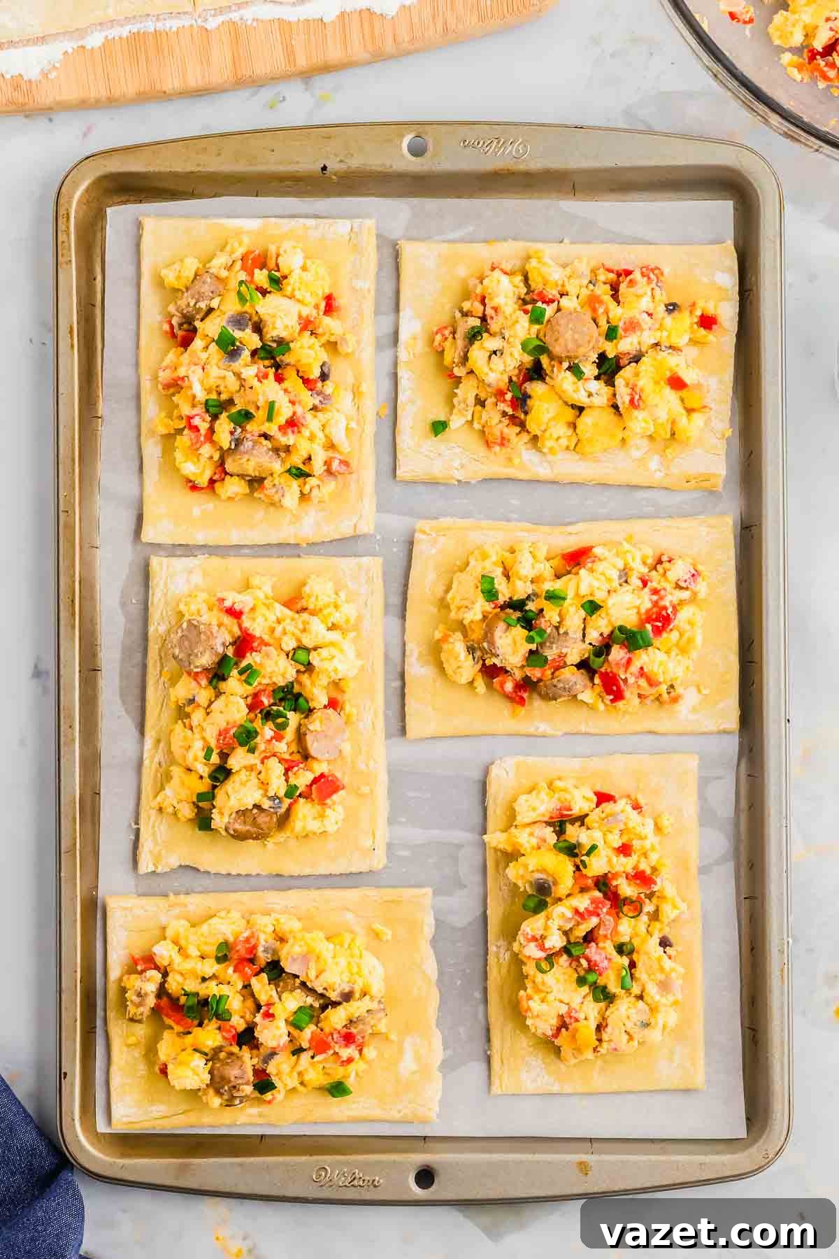 Artisan Stuffed Pockets 8 Making hot pockets with puff pastry on a baking sheet.