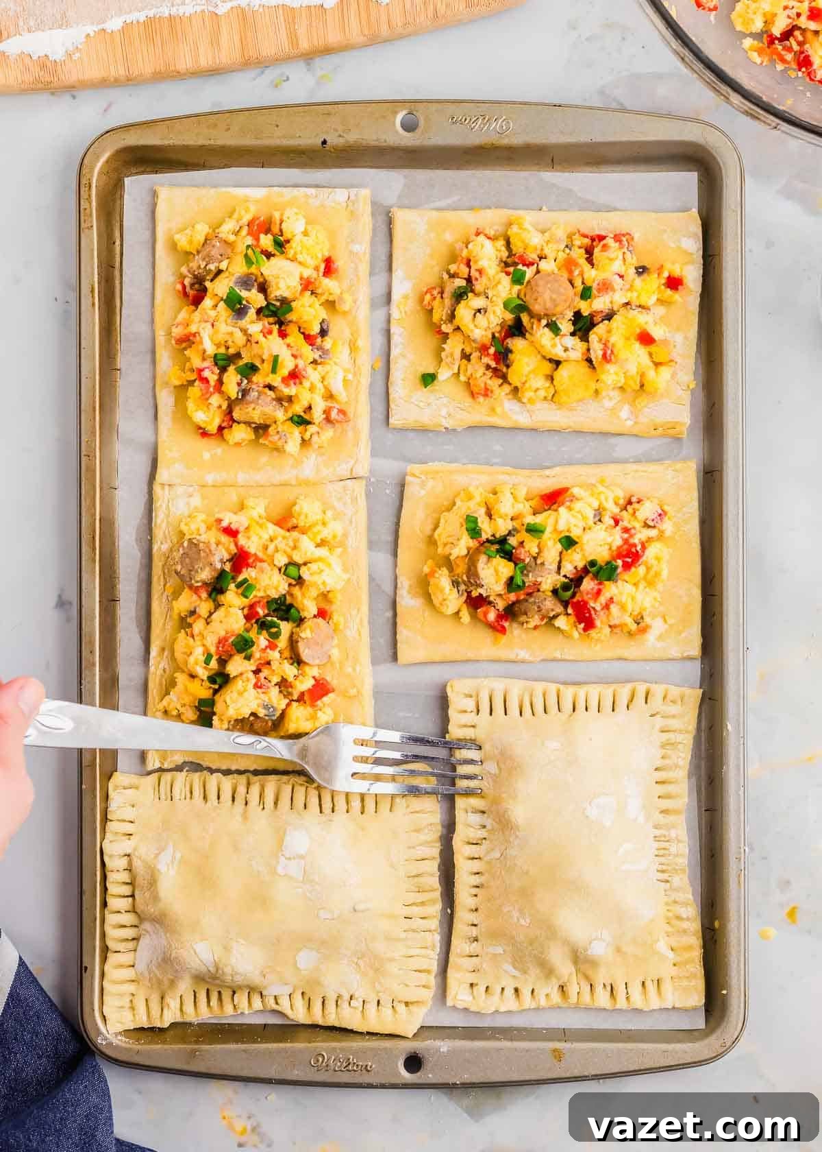 Artisan Stuffed Pockets 9 Using a fork to crimp the edges of breakfast hot pockets.