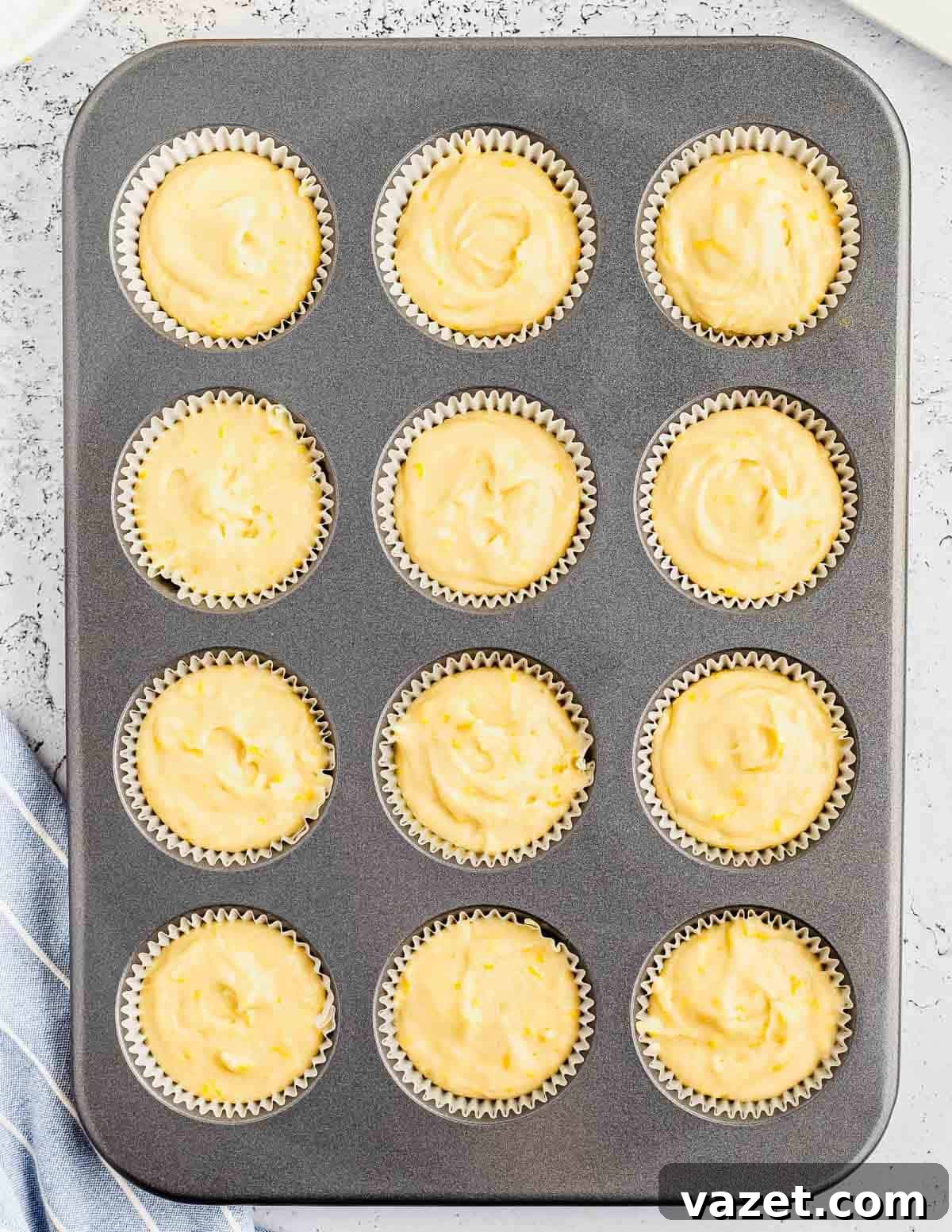 Zesty Orange Muffins 4 A muffin tin filled with unbaked orange muffin batter, perfectly portioned.
