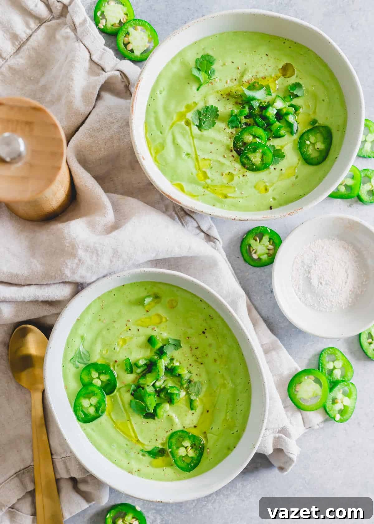 Cold avocado soup in bowls garnished with jalapeño and cilantro. Cold avocado soup in bowls garnished with jalapeño and cilantro.