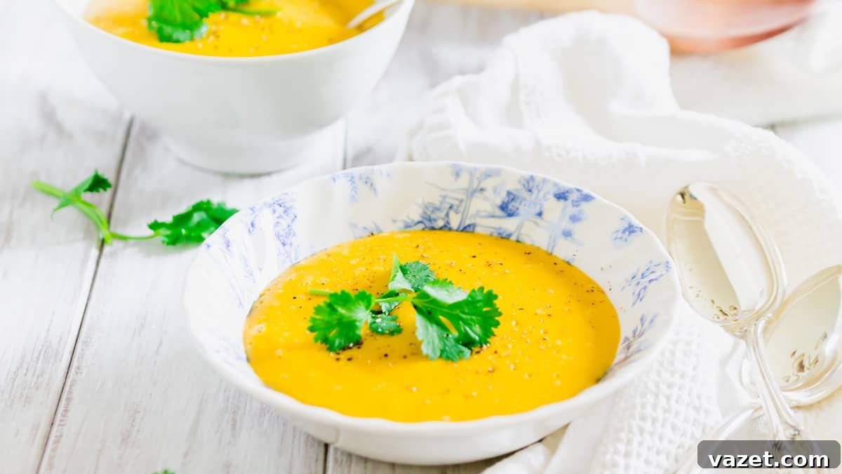 Velvety Pumpkin Potato Soup 3 Creamy potato pumpkin soup in a bowl, garnished with fresh parsley and cracked black pepper.