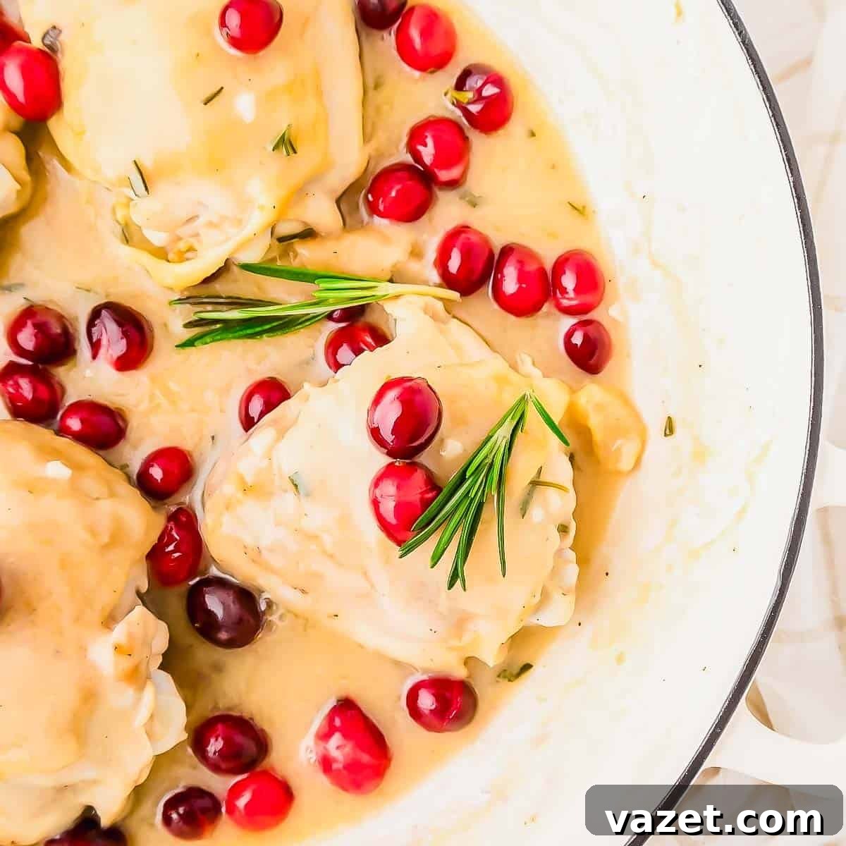 Cranberry Chicken Delight 5 Chicken thighs with cranberries and rosemary in a skillet.
