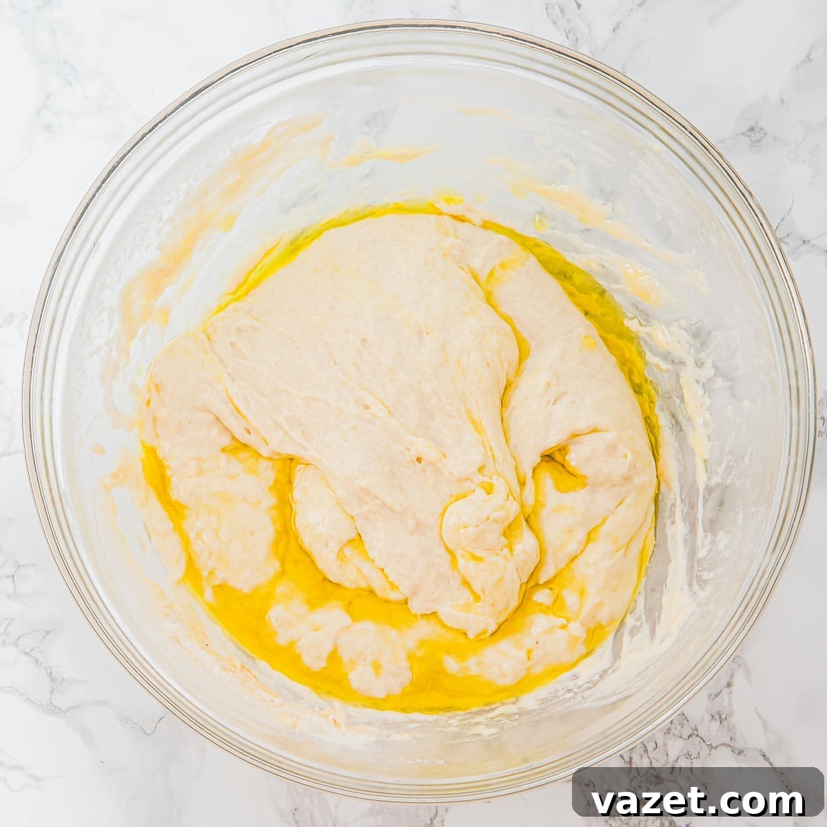 Focaccia dough partially mixed with olive oil.