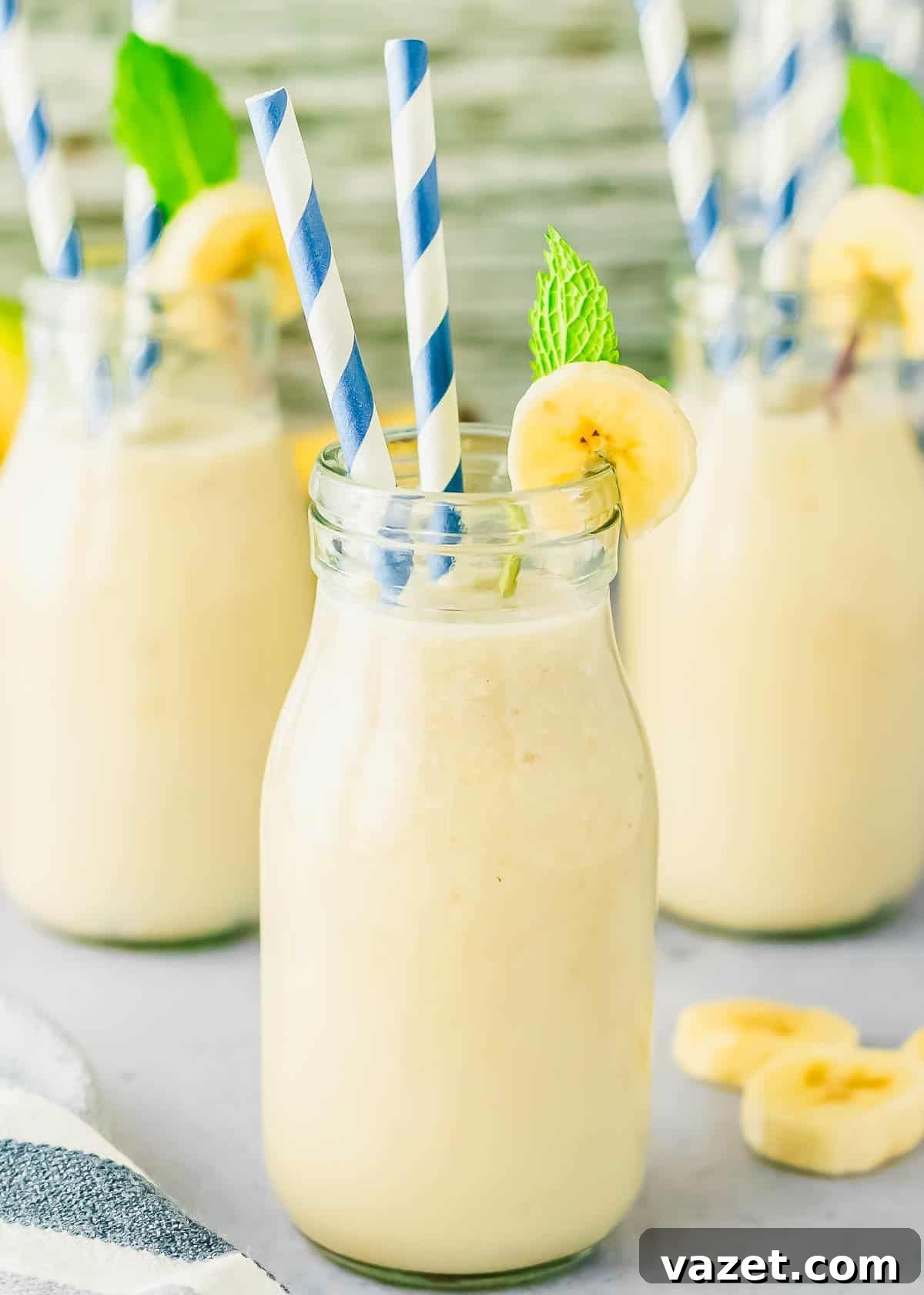 Korean Banana Bliss 2 Homemade Korean banana milk in a glass bottle, garnished with a banana slice and mint sprig