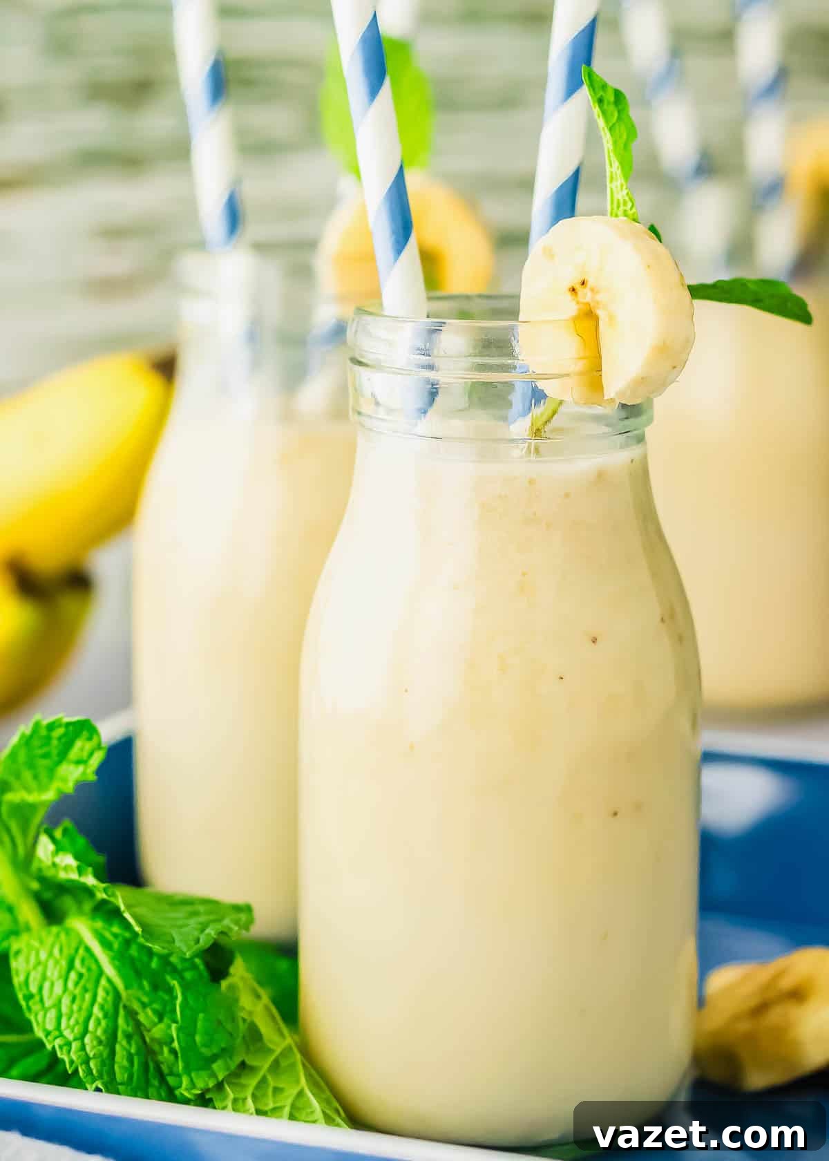 Korean Banana Bliss 9 Homemade banana milk in a glass with a banana slice and mint leaf.