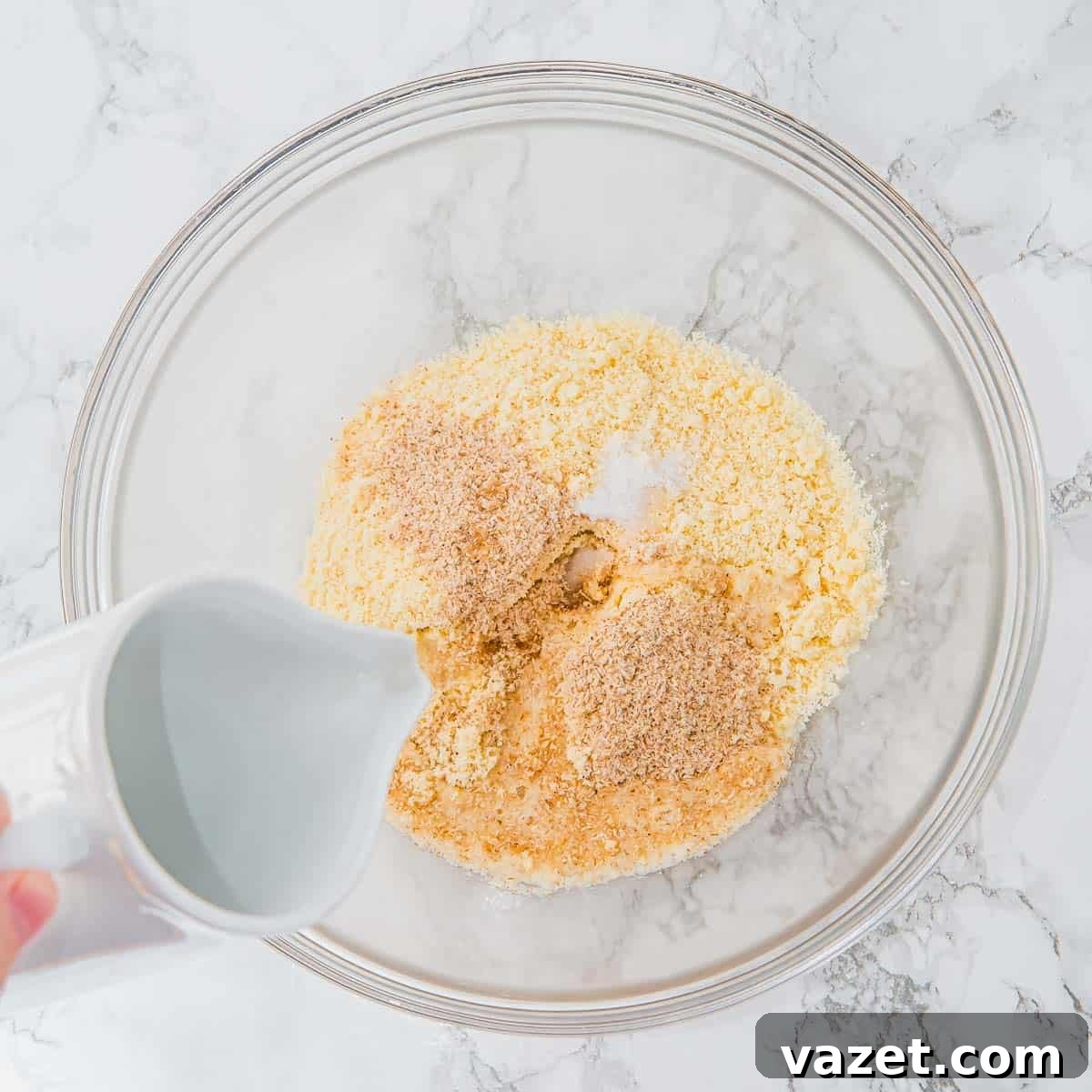 Combining dry ingredients in a bowl.