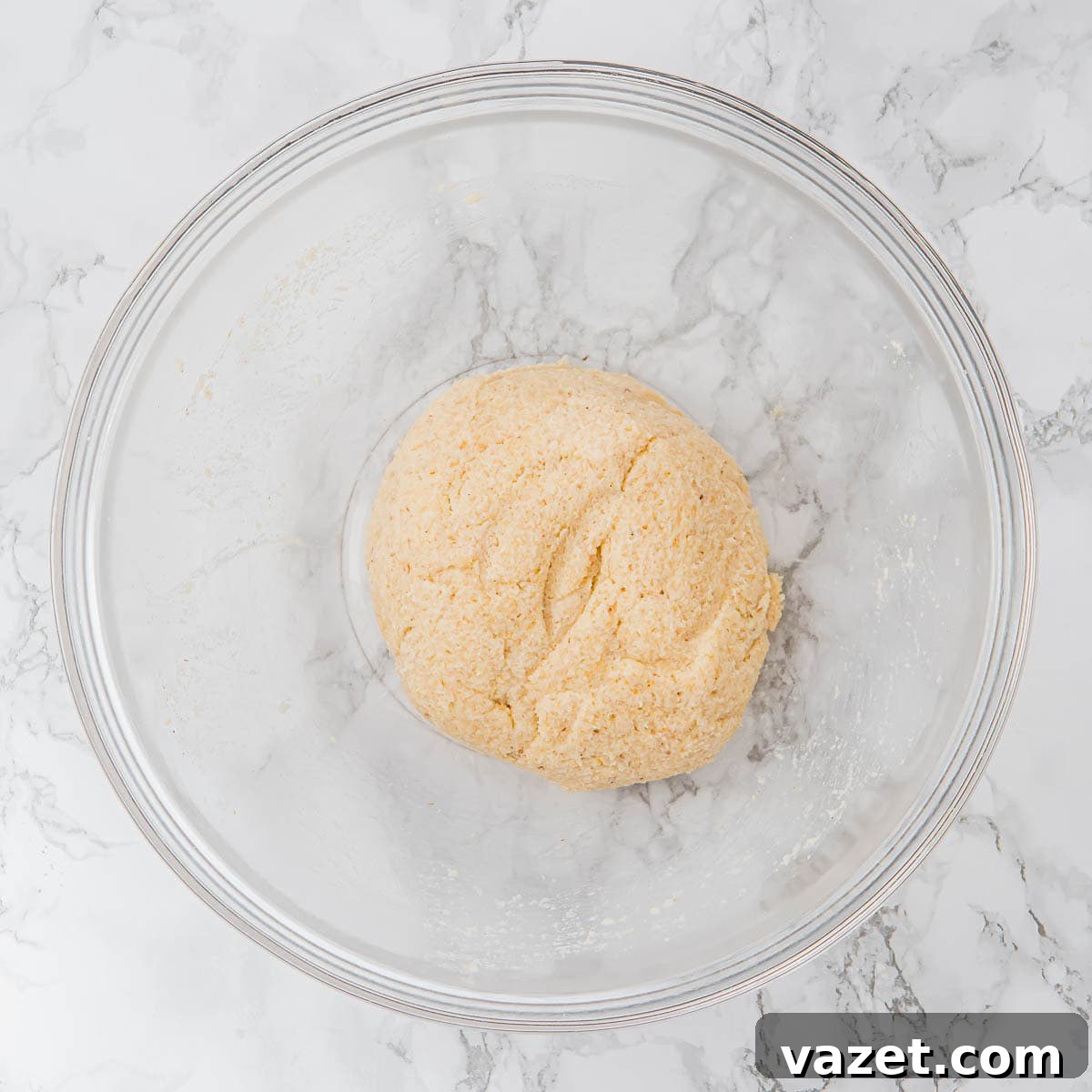 Dough ball resting in a bowl.