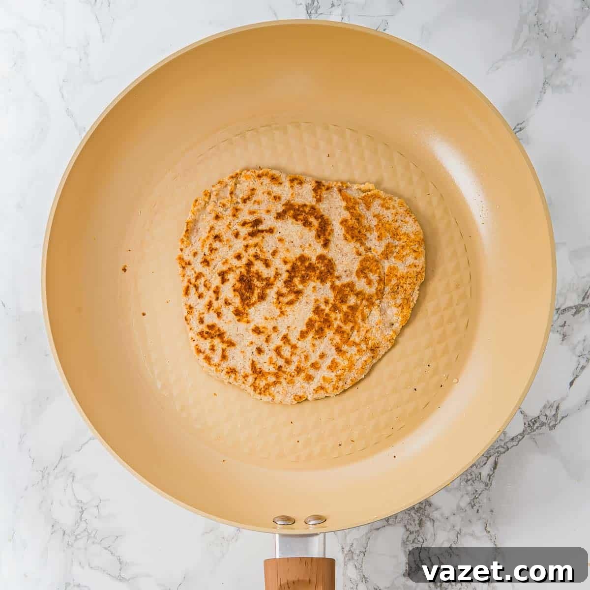 Cooking the tortilla in a skillet.