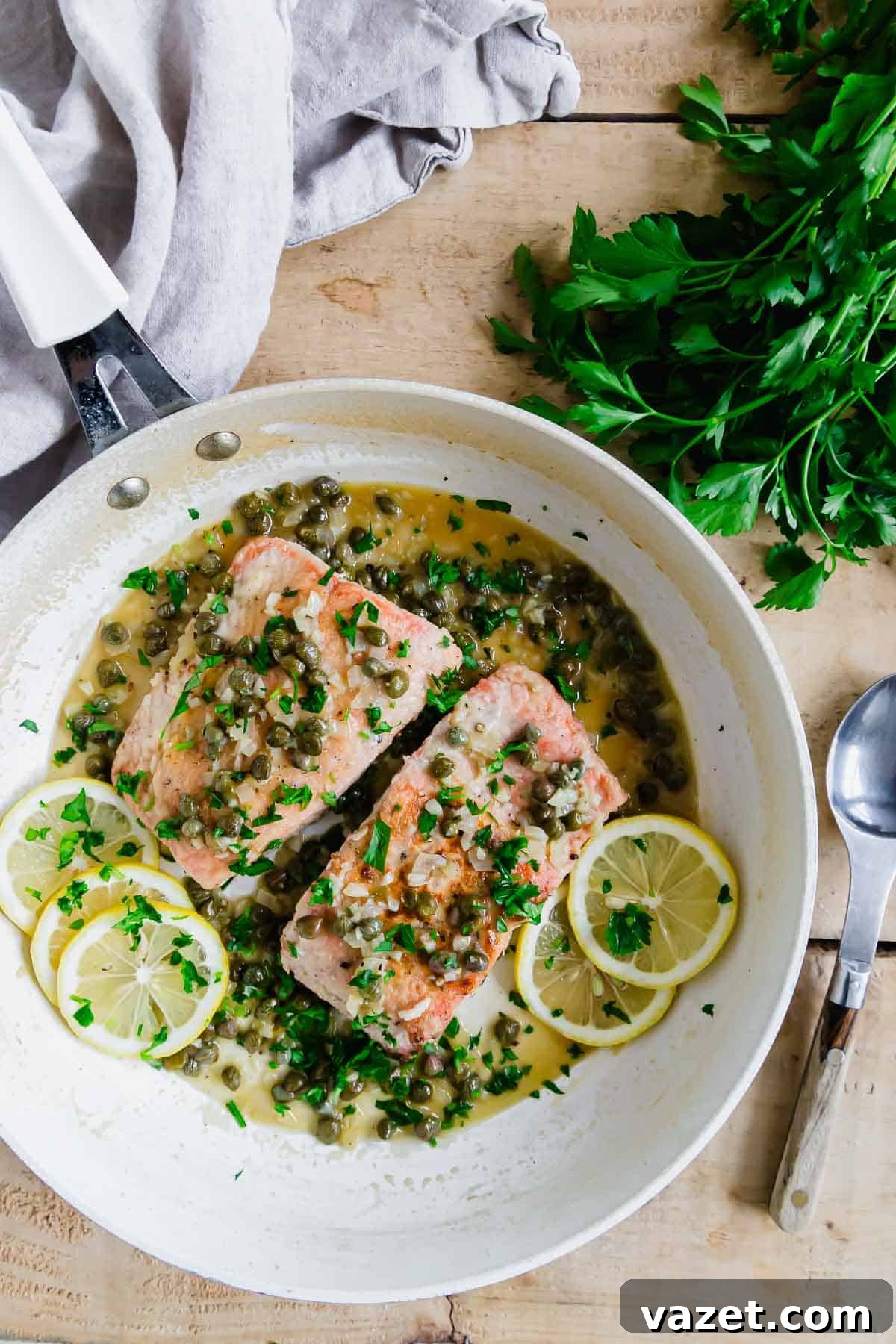 Lemon Butter Salmon Piccata with Capers and Parsley 8 Salmon piccata recipe in a white pan.