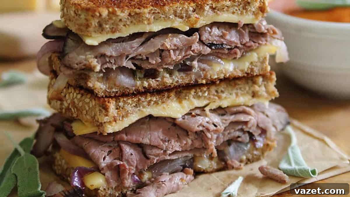 A grilled sandwich with meat and cheese on top.