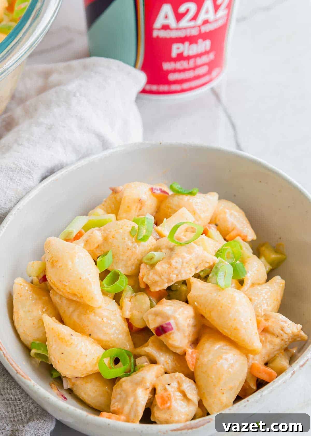 Spicy Buffalo Chicken Pasta Salad with Creamy Ranch 4 Creamy chicken potato salad garnished with green onions in a white bowl.